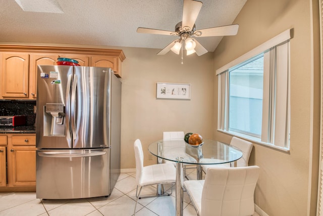 kitchen with stainless steel fridge with ice dispenser, ceiling fan, a healthy amount of sunlight, and a textured ceiling