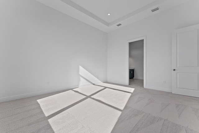 unfurnished bedroom with connected bathroom and light colored carpet