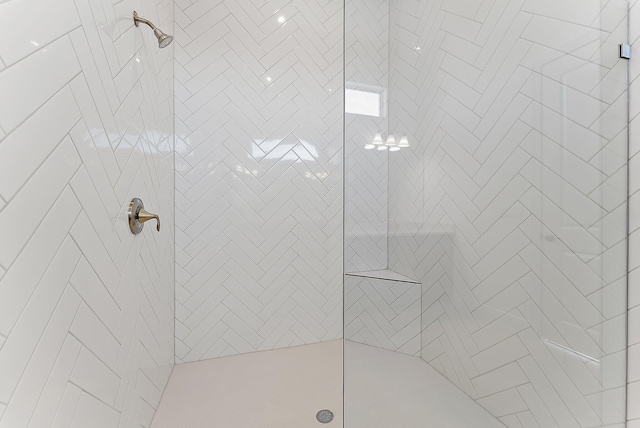 bathroom with tiled shower