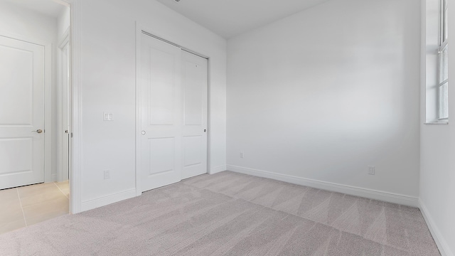 unfurnished bedroom with light colored carpet