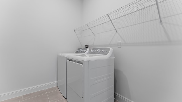 laundry room featuring independent washer and dryer and light tile patterned floors