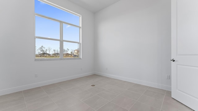 unfurnished room with light tile patterned floors and a healthy amount of sunlight