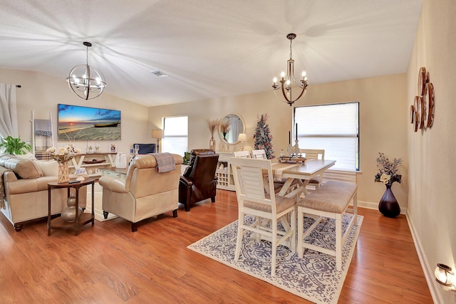 dining room featuring hardwood / wood-style floors and a notable chandelier