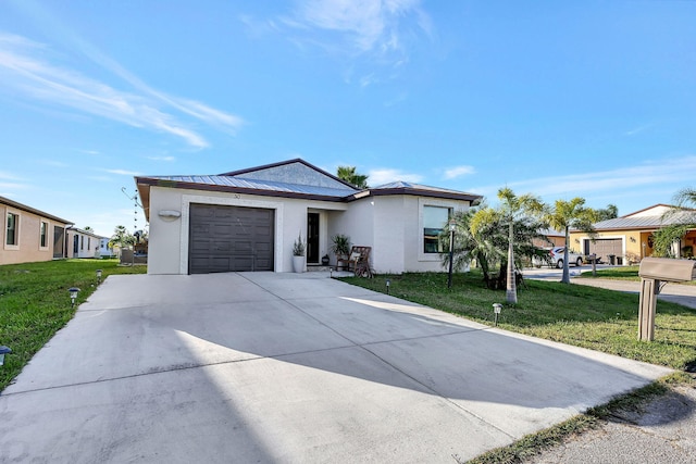 view of front of home with a front lawn and a garage