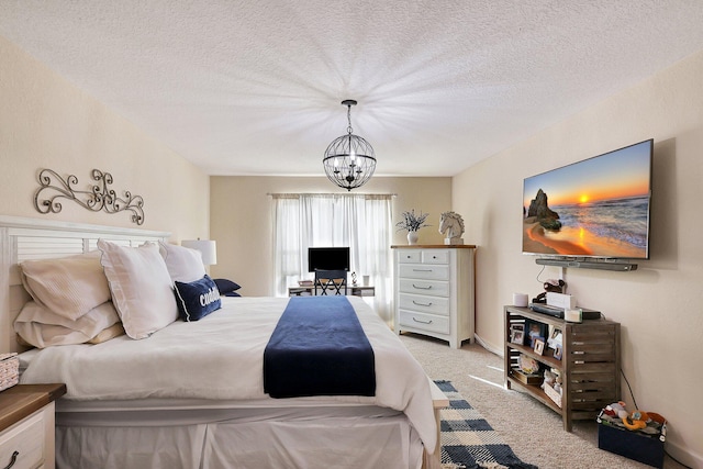 bedroom featuring carpet, a textured ceiling, and a chandelier