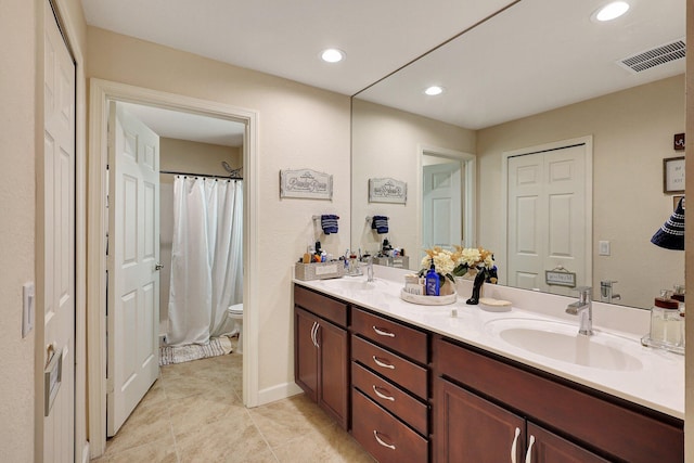 bathroom with tile patterned floors, vanity, and toilet