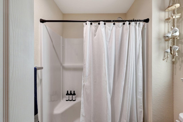 bathroom featuring a shower with curtain