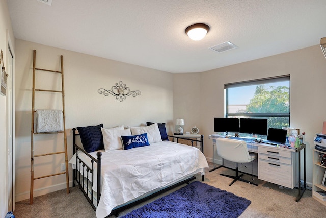 carpeted bedroom with a textured ceiling