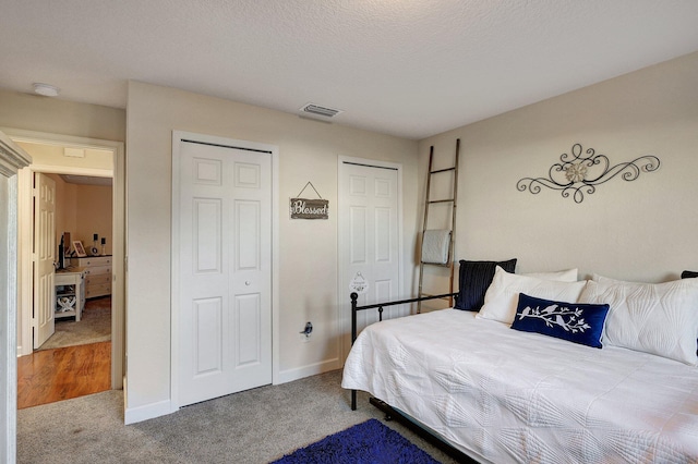 carpeted bedroom featuring a textured ceiling