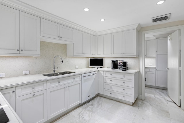 kitchen with dishwasher, tasteful backsplash, white cabinetry, and sink