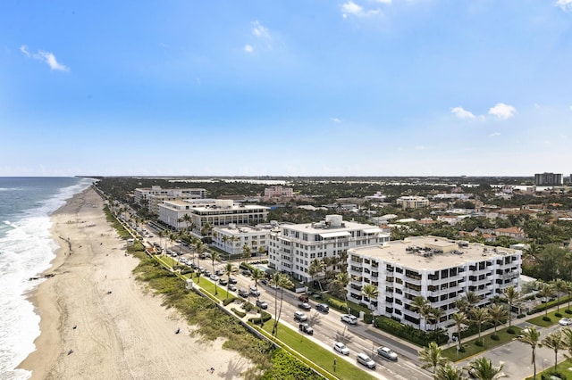 drone / aerial view with a water view and a beach view