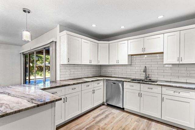 kitchen with stone counters, white cabinetry, sink, light hardwood / wood-style flooring, and stainless steel dishwasher