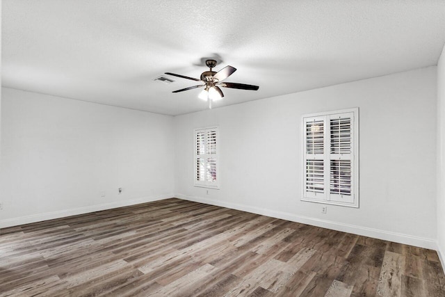 empty room featuring hardwood / wood-style floors and a textured ceiling