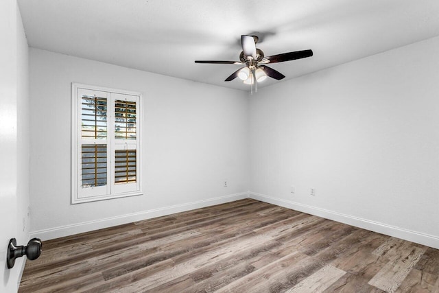 unfurnished room featuring dark hardwood / wood-style floors and ceiling fan