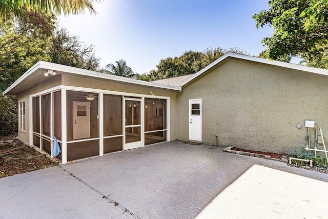 back of house with a sunroom and a patio