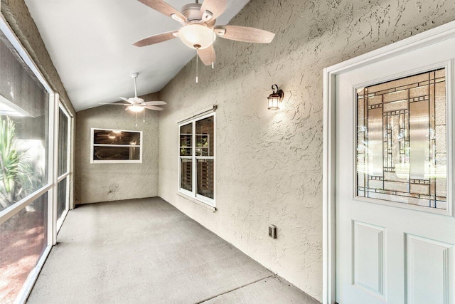 unfurnished sunroom featuring ceiling fan and vaulted ceiling