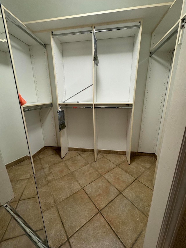 walk in closet with tile patterned floors