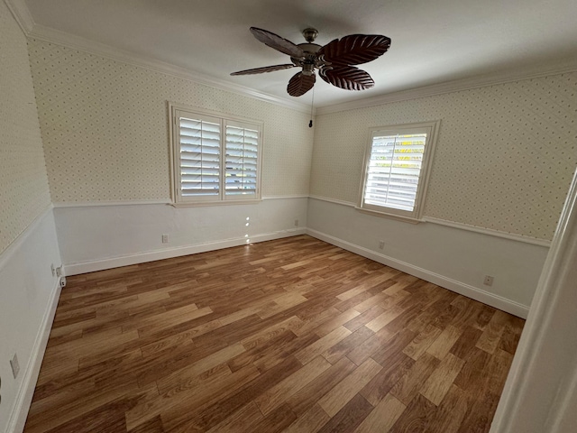 empty room featuring hardwood / wood-style flooring, ceiling fan, and ornamental molding