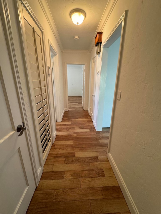 hall featuring crown molding and light hardwood / wood-style floors