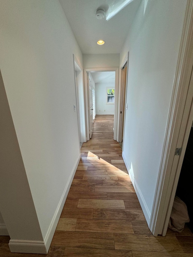 hallway with light hardwood / wood-style floors