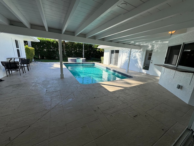 view of swimming pool featuring a patio area and a jacuzzi