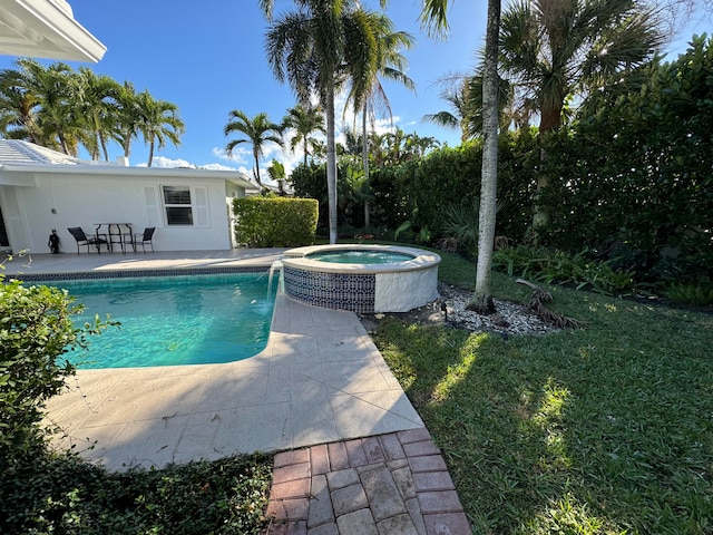 view of pool featuring a lawn, a patio area, and an in ground hot tub