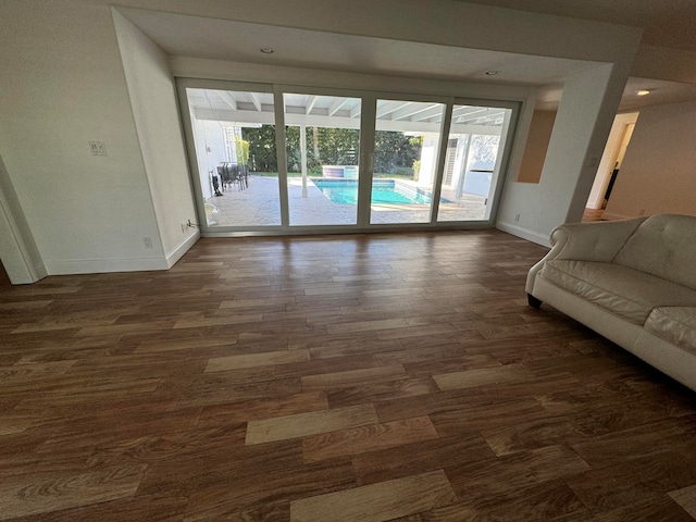 unfurnished living room with dark hardwood / wood-style floors