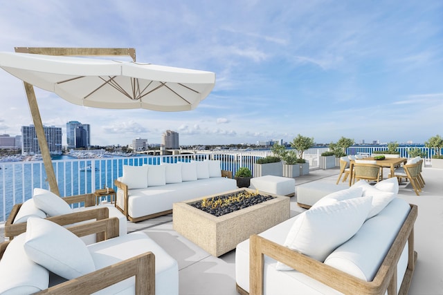 view of patio / terrace with a water view and an outdoor living space with a fire pit