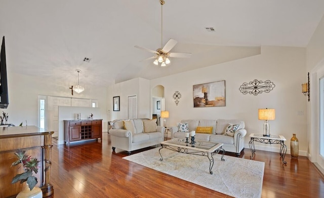 living room with dark hardwood / wood-style floors, vaulted ceiling, and ceiling fan