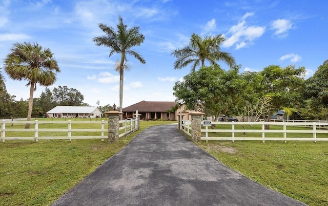 view of front facade featuring a front yard and a rural view