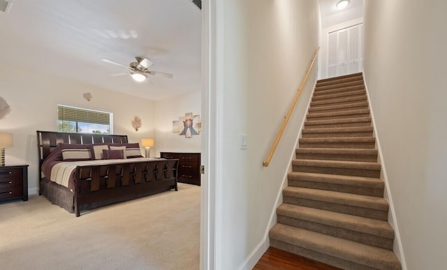 bedroom featuring light colored carpet and ceiling fan