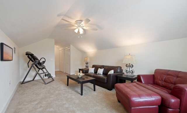 living room featuring ceiling fan, lofted ceiling, and light carpet