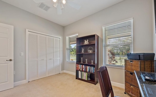 carpeted office featuring ceiling fan