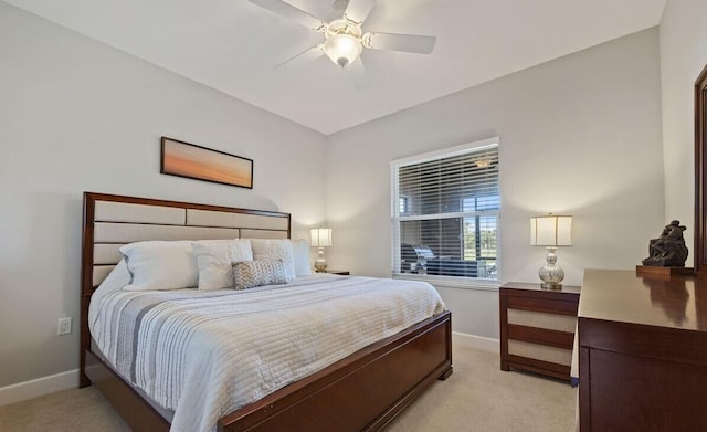 bedroom with ceiling fan and light colored carpet