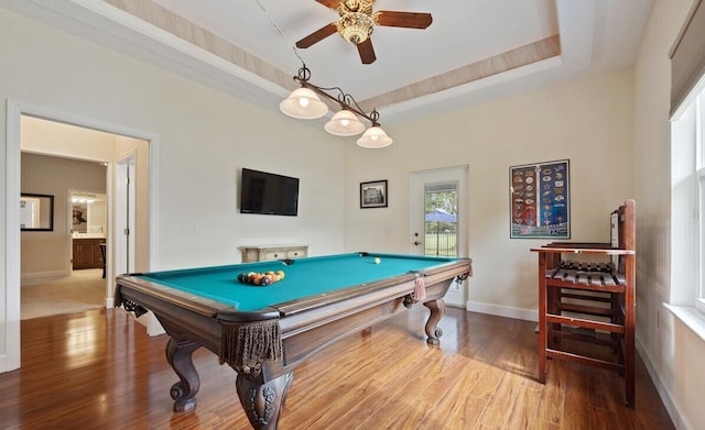 recreation room with a raised ceiling, ceiling fan, billiards, and hardwood / wood-style flooring