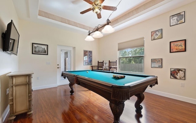 recreation room with hardwood / wood-style flooring, ceiling fan, billiards, and a tray ceiling