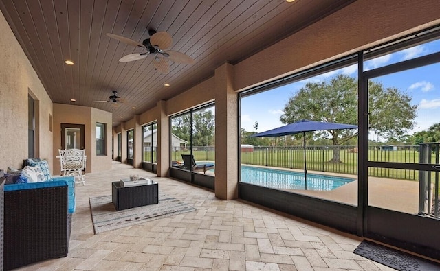 unfurnished sunroom featuring ceiling fan and wood ceiling