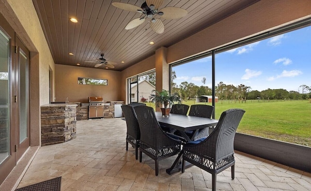 sunroom / solarium with ceiling fan and wood ceiling