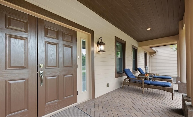 view of exterior entry with covered porch