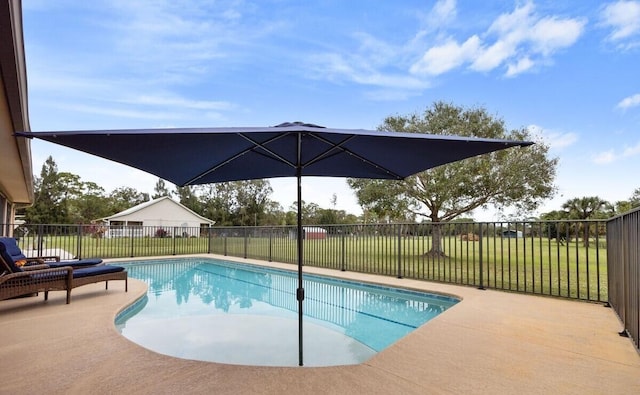 view of swimming pool with a lawn and a patio area