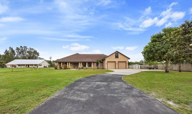 view of front of home with a front lawn and a garage