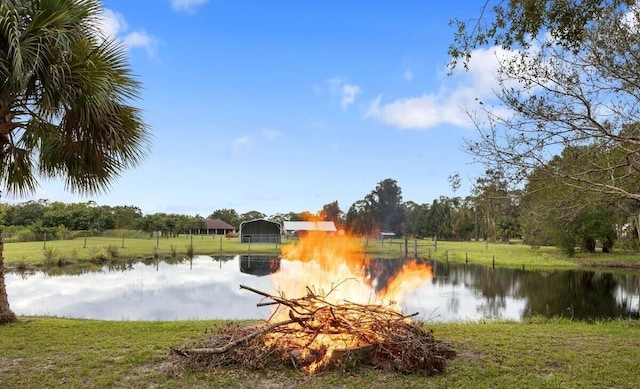 property view of water featuring a fire pit