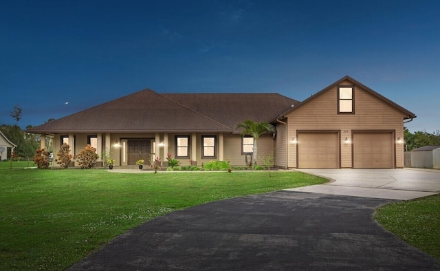 view of front facade featuring a garage and a lawn