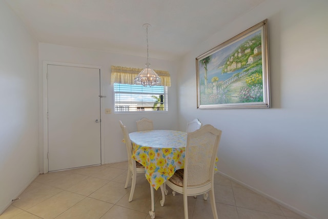 dining space featuring light tile patterned floors and an inviting chandelier