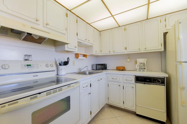 kitchen featuring light tile patterned flooring, white appliances, white cabinetry, and sink