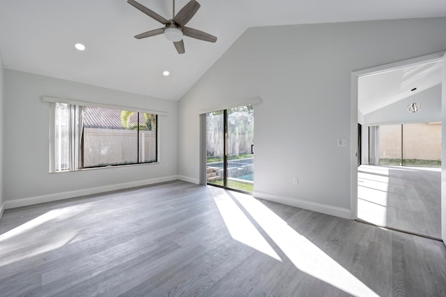 unfurnished living room featuring wood-type flooring, high vaulted ceiling, and ceiling fan