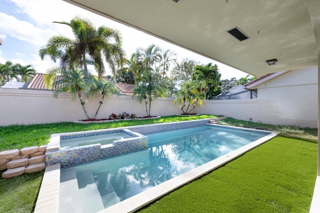 view of pool featuring an in ground hot tub and a yard