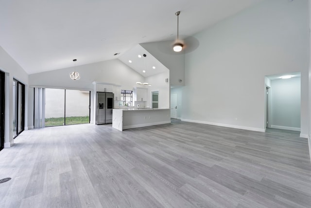 unfurnished living room featuring ceiling fan, light hardwood / wood-style floors, and high vaulted ceiling