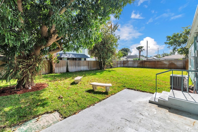 view of yard featuring a patio and central AC unit