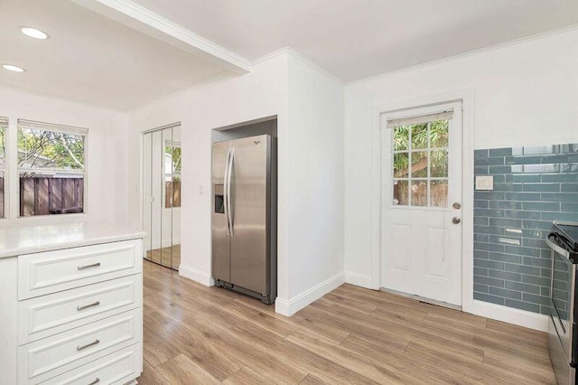 6312 Garden Ave, West Palm Beach, FL 33405 - foyer featuring healthy amount of natural light, light wood-style flooring, ornamental molding, baseboards, and recessed lighting
